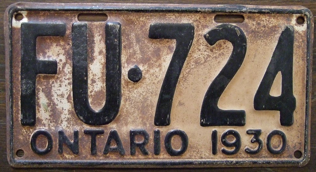 Rust-worn 1930 Ontario licence plate bearing the number FU·724